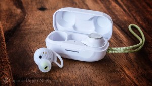 image of the JBL Reflect Aero True Wireless Workout Earbuds and their charging case on a wood countertop