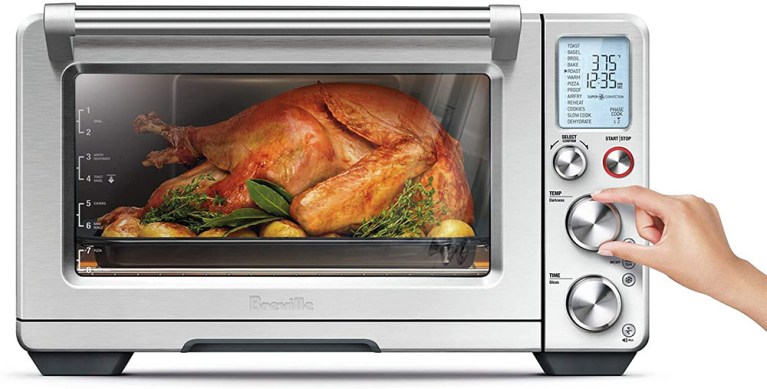 Image of a Breville Smart Oven Air Fryer Pro with a large chicken roasting inside it.